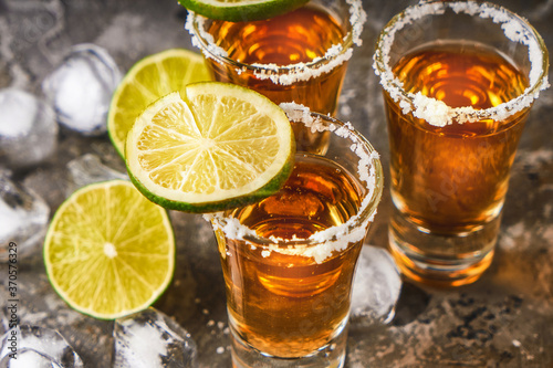 Appetizing tequila with lime and salt in a glass with ice