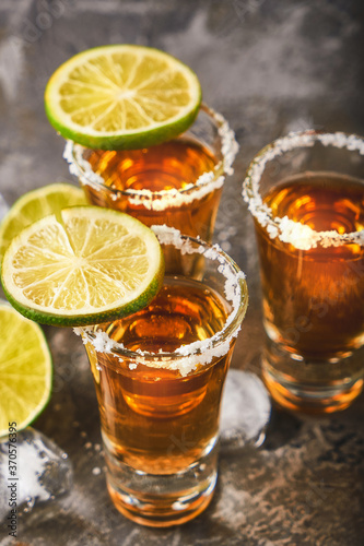 Appetizing tequila with lime and salt in a glass with ice