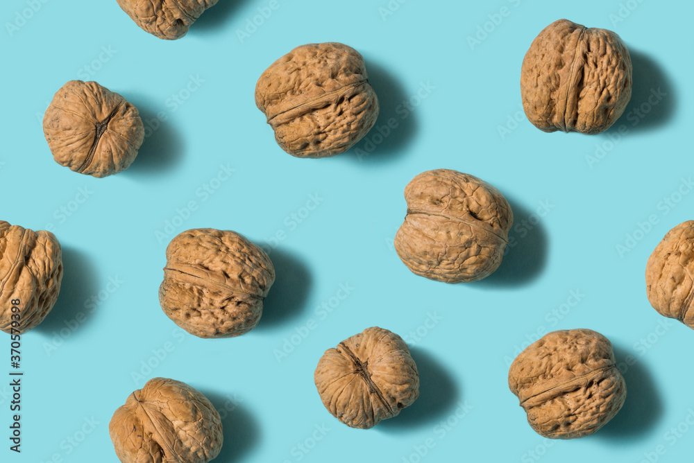 Top view of Walnut isolated on blue background. Minimal concept. Flat lay. Pattern Top view of Walnut isolated on blue background. Minimal concept. Flat lay. Pattern