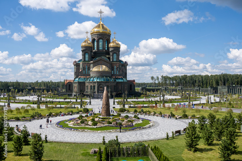 panoramic view of a dark temple with golden domes against a background of gray clouds
