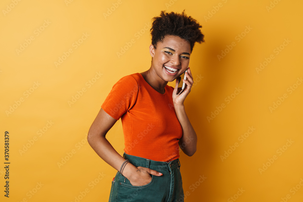 Image of african american woman laughing and talking on mobile phone Image of african american woman laughing and talking on mobile phone