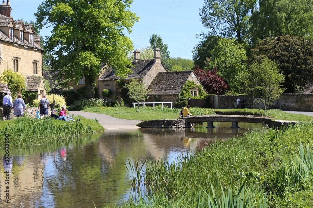 Picturesque Cotswold cottages beside the River Eye in Lower Slaughter, Gloucestershire, England.