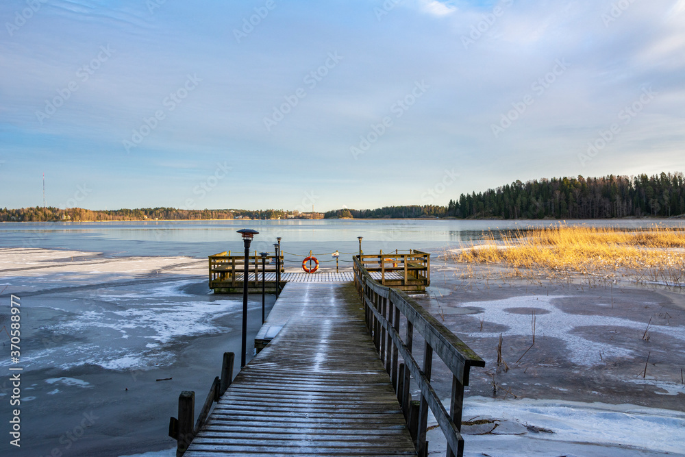 Naklejka premium Wooden pier on the shore and view to The Gulf of Finland, Majvik, Kirkkonummi, Finland