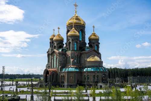 panoramic view of a dark temple with golden domes against a background of gray clouds