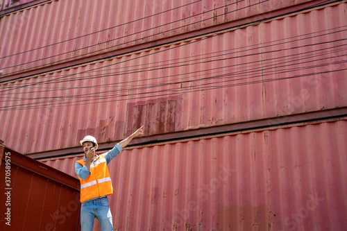 Container worker loading containers box for import export at industrial container cargo.