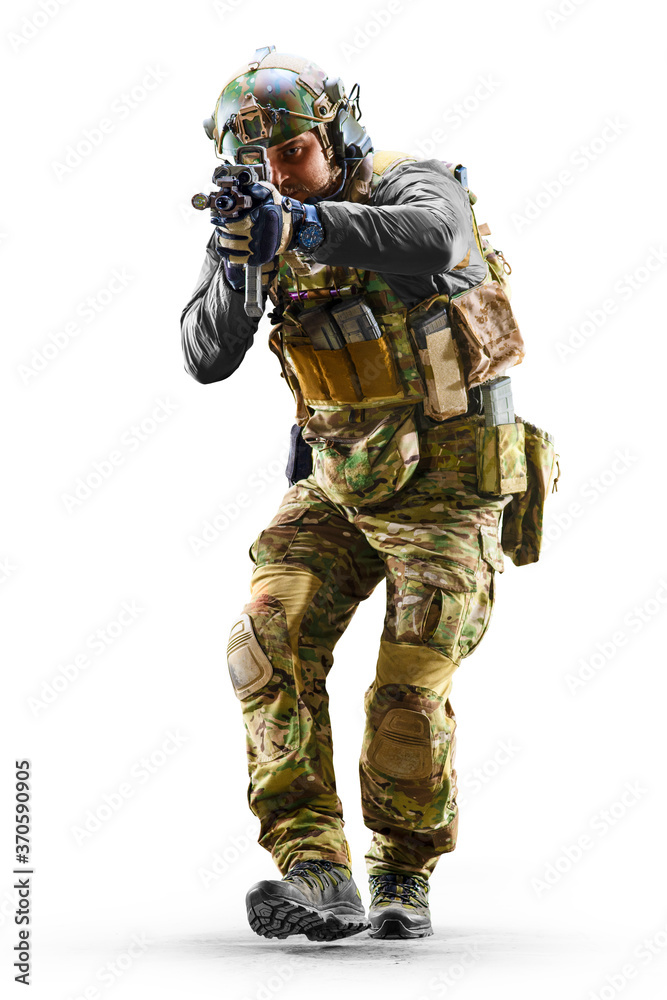 Army soldier in Protective Combat Uniform holding Special Operations Forces Combat Assault Rifle isolated on white background Army soldier in Protective Combat Uniform holding Special Operations Forces Combat Assault Rifle isolated on white background