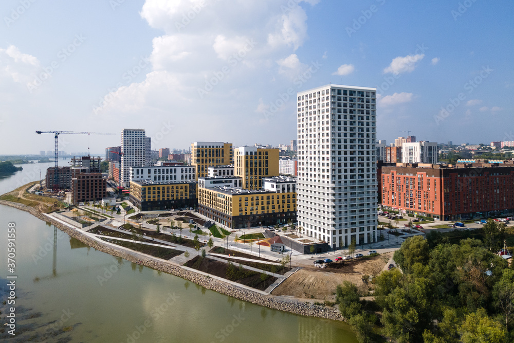 Fototapeta premium modern residential complex in a large city on the river bank. view from the plane