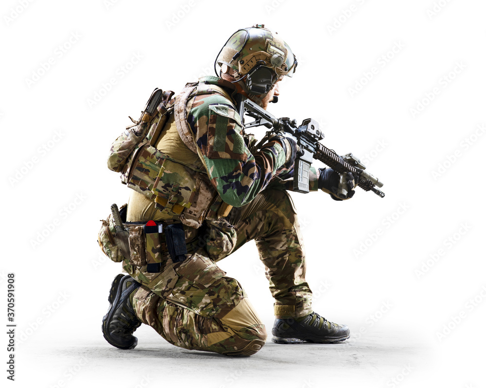 Army soldier in Protective Combat Uniform holding Special Operations Forces Combat Assault Rifle isolated on white background Army soldier in Protective Combat Uniform holding Special Operations Forces Combat Assault Rifle isolated on white background
