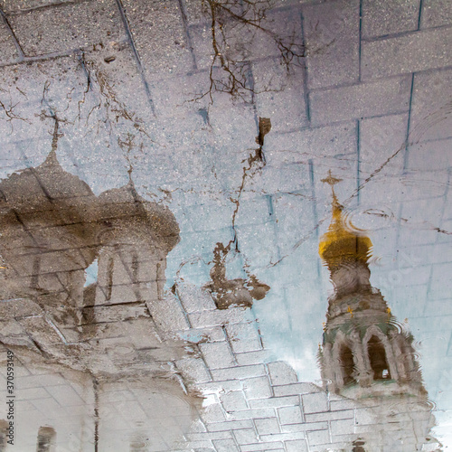 Photography Puddle reflection of old orthodox cathedral with bell tower