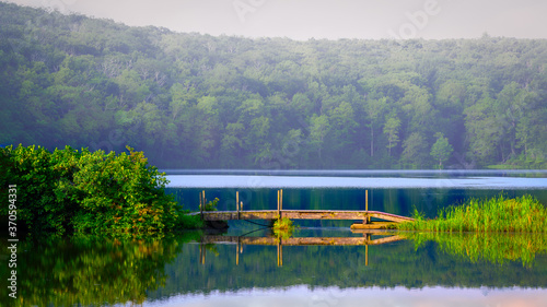 Wooden footbridge on Lake Ashroe at Stokes State Forest in New Jersey