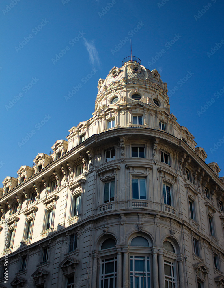 Domed building in Genoa, Italy with blue sky background