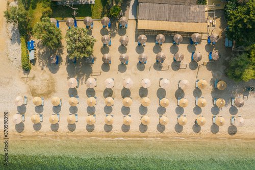 Sun umbrellas at empty beach in Afissos, Greece photo