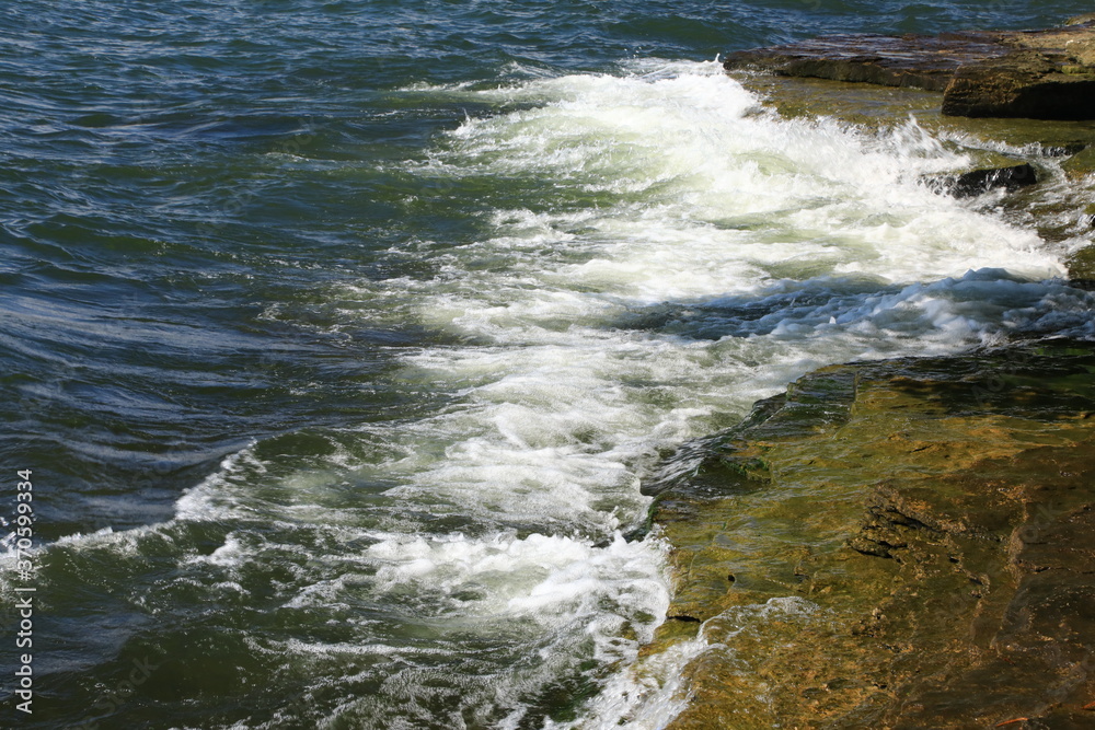Splashing waves against the rocks on the shore
