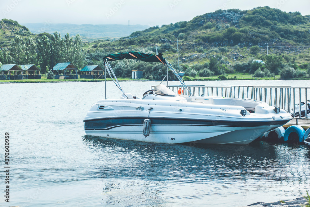 Fototapeta premium vacation, travel and sea concept - white boat at blue sea