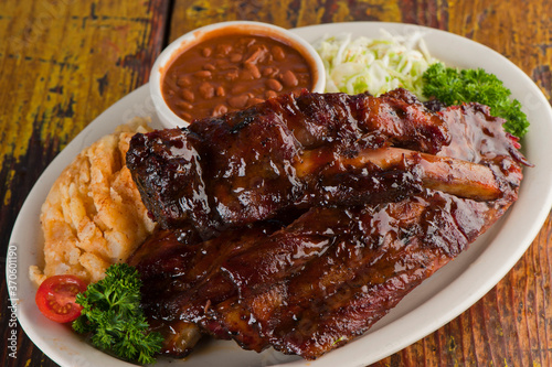 Brisket, pork sausage, pork ribs, beef ribs. Barbecue platter served with classic bbq sides Mac n cheese, cornbread, Brussels sprouts, coleslaw & beer. Classic traditional Texas meats & side dishes.