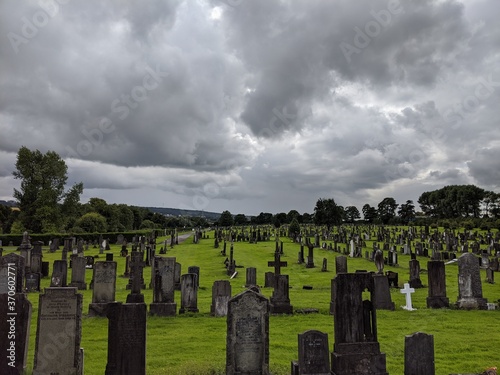 old graveyard with grey sky and clouds