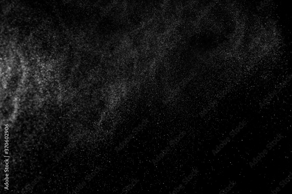 Abstract splashes of water on black background. Freeze motion of white particles. Rain, snow overlay texture. Abstract splashes of water on black background. Freeze motion of white particles. Rain, snow overlay texture.