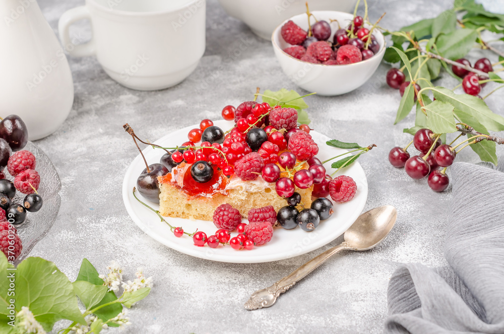 Biscuit cake with summer berries, side view Biscuit cake with summer berries, side view