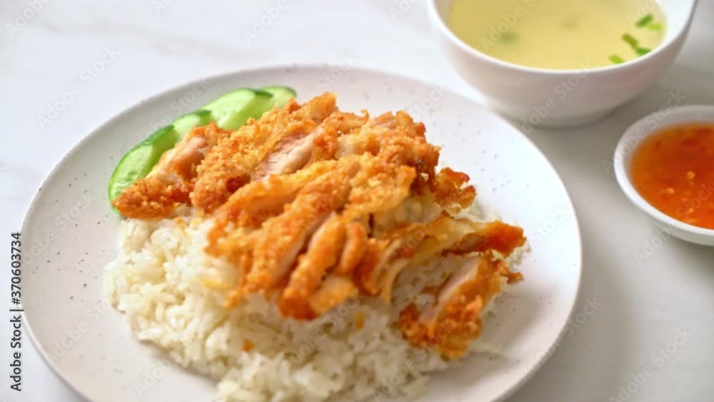 Hainanese chicken rice with fried chicken or rice steamed chicken soup with fried chicken - Asian food style Hainanese chicken rice with fried chicken or rice steamed chicken soup with fried chicken - Asian food style