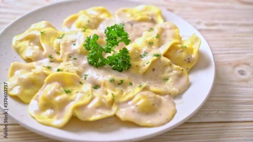 ravioli pasta with mushroom cream sauce and cheese - Italian food style ravioli pasta with mushroom cream sauce and cheese - Italian food style