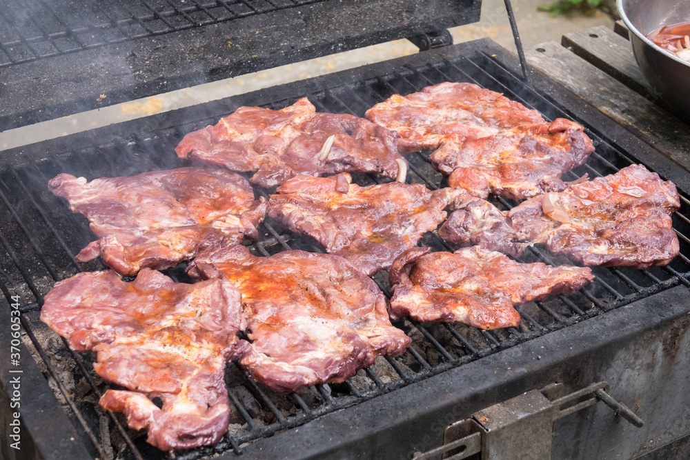 Tasty steaks on barbecue. Meat during grilling. Tasty steaks on barbecue. Meat during grilling.