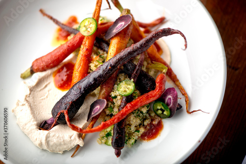 Carrots. Roasted caramelized carrots. Bunch of farm fresh farm to market rainbow carrots. Organic root vegetable, ingredients for menu items at traditional American or french bistro restaurants. 