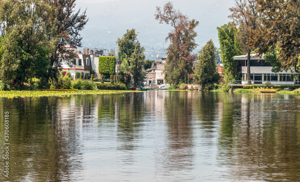 Landscape of the Cuemanco canal in Xochimilco, Mexico City. Calm river. The river flows in spring through the forest.