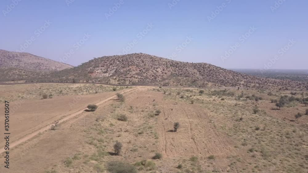 Golden Sunlight Over The Broad Barren Field In Rajasthan, India - wide shot Golden Sunlight Over The Broad Barren Field In Rajasthan, India - wide shot