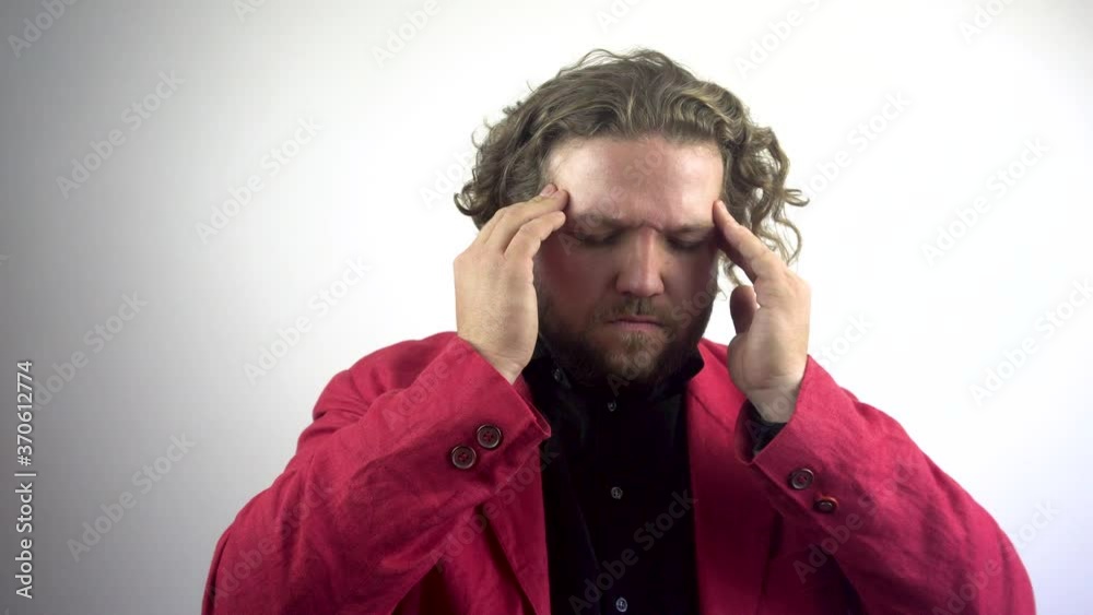 Headache, stressful work overload for a businessman.Young businessman with headache. A man in a red jacket massages his head, forehead. The young man has a headache.White background.4k Headache, stressful work overload for a businessman.Young businessman with headache. A man in a red jacket massages his head, forehead. The young man has a headache.White background.4k
