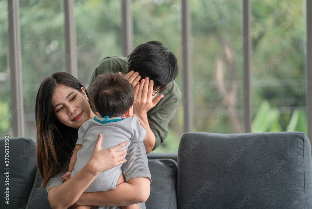 Diversity Lesbian sitting with cute toddler girl in between. Happiness and family bonding in LGBTQ family, LGBT lifestyle. Diversity Lesbian sitting with cute toddler girl in between. Happiness and family bonding in LGBTQ family, LGBT lifestyle.