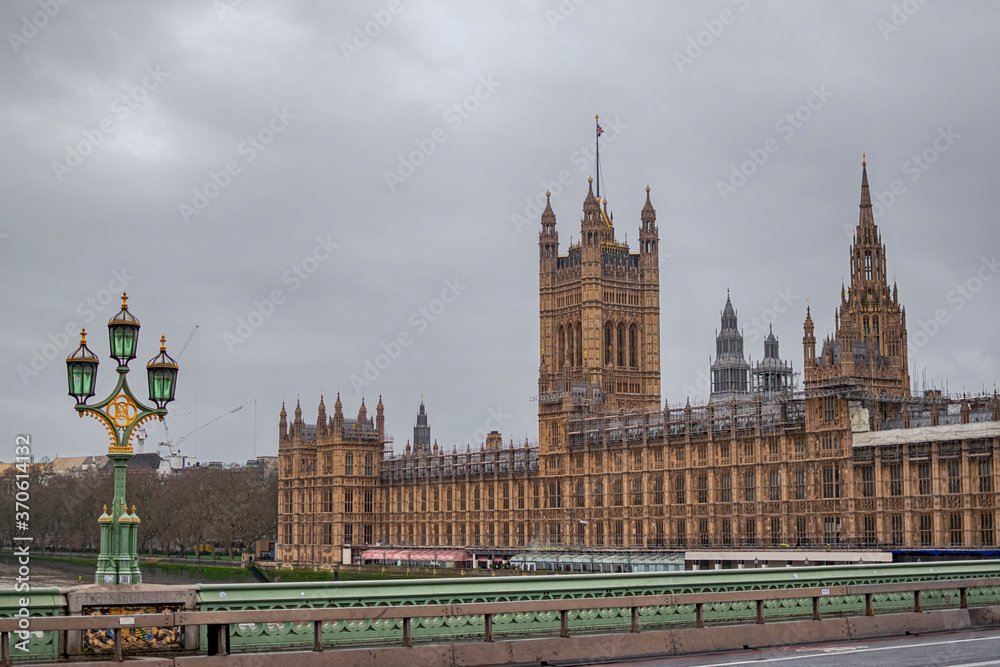 View of the Palace of Westminster on a cloudy day from Westminster Bridge over the River Thames. Photograph taken in London, England, United Kingdom.