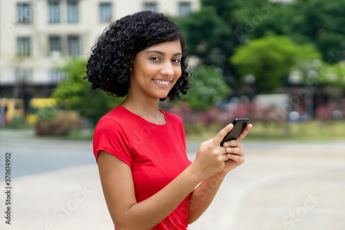Video call of brazilian young adult woman with mobile phone