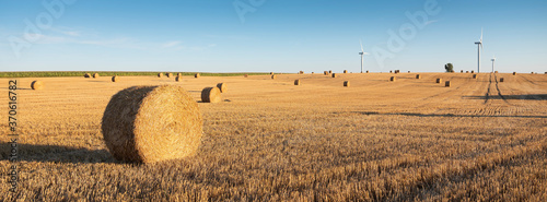 fields after harvest in the north of france with wind turbines in the background