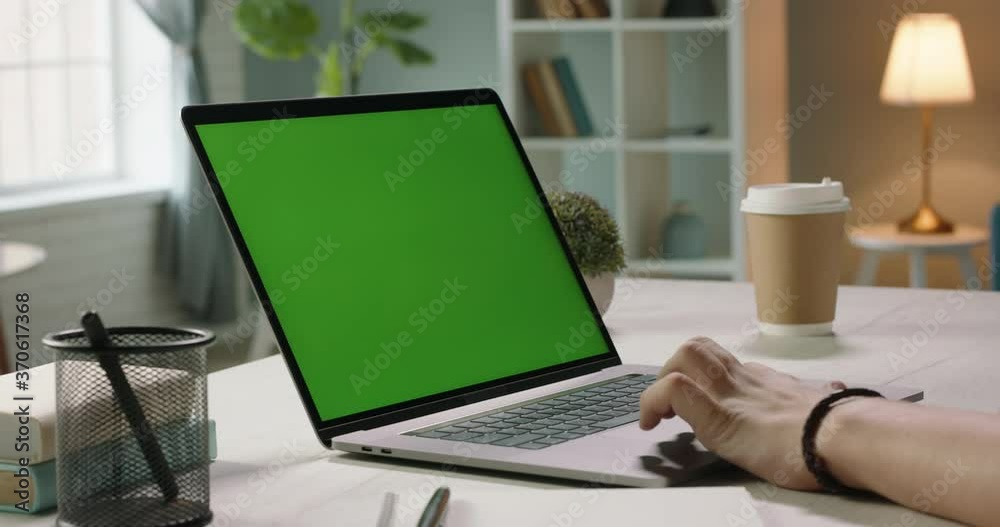 Close up shot of hands of freelancer working with chroma key green