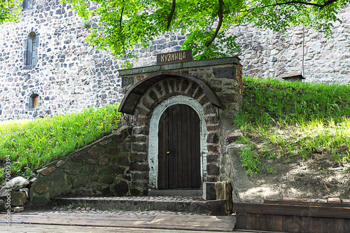 Fototapeta Naklejka Na Ścianę i Meble -  The inner courtyard of the medieval knight's castle. Forge. Vyborg, Russia, June 2020