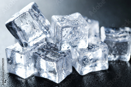 Ice cubes with water drops on black background