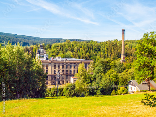 Old textile factory called Klaster, Monastery, with high chimney in summer time, Tanvald, Northern Bohemia, Czech Republic, Europe photo