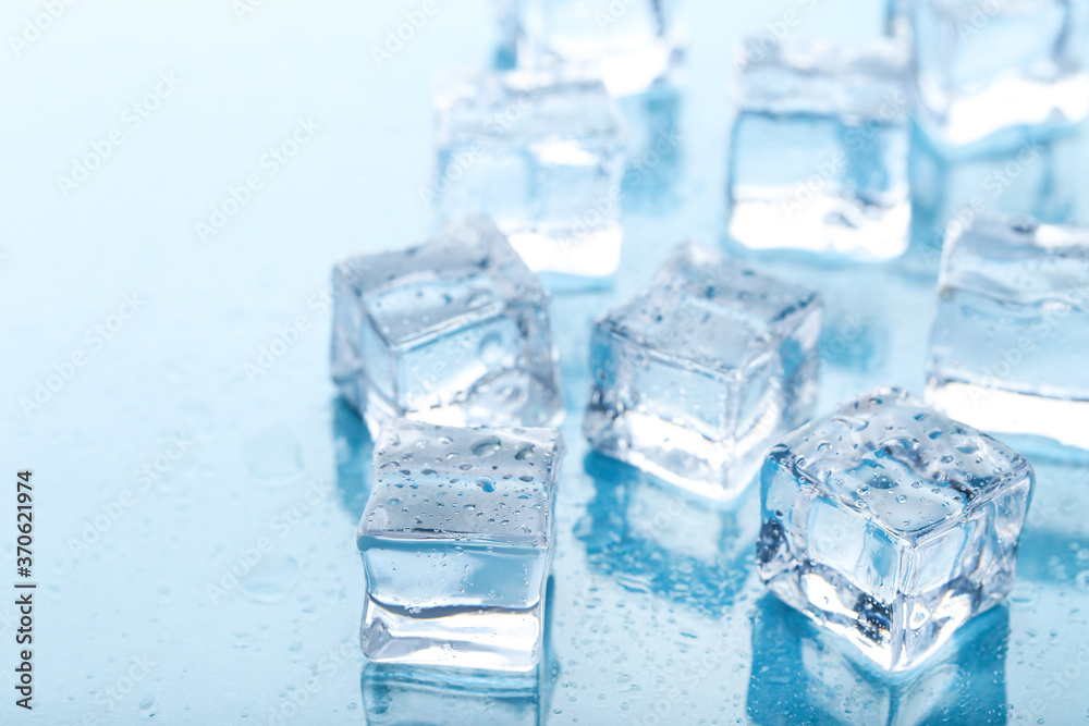 Ice cubes with water drops on blue background Ice cubes with water drops on blue background