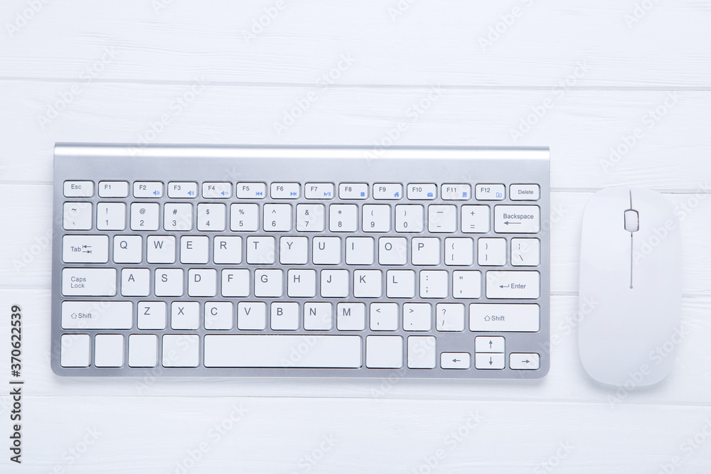 Computer keyboard and mouse on wooden table Computer keyboard and mouse on wooden table
