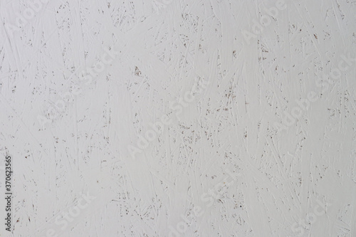 gray painted fiberboard texture with cracks and scuffs. Abstract background for design and decoration