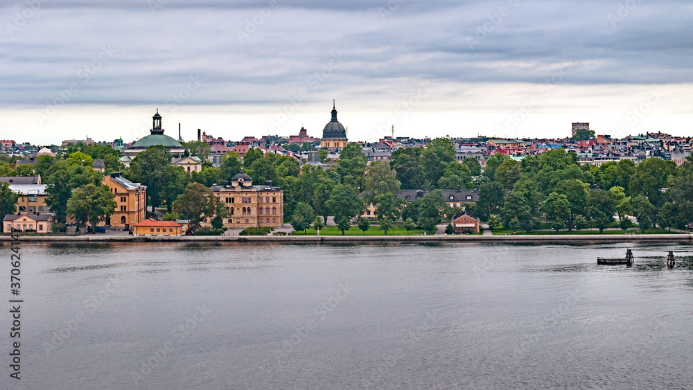 Panoramic view of different parts of Stockholm from the observation deck, cloudy summer day with blurry small fragments in the corners of the card