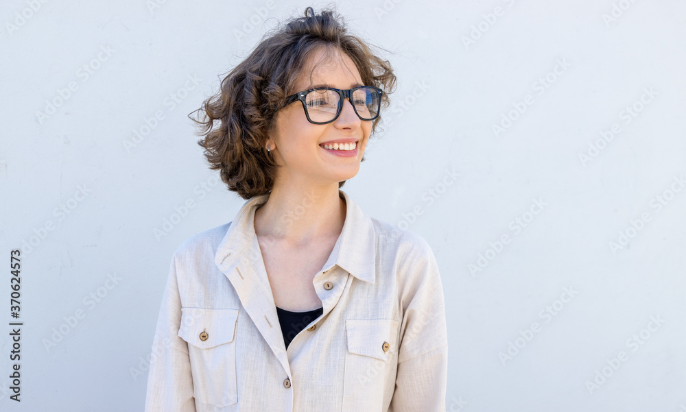 Girl student looks to the right. Portrait  young beautiful woman in glasses.