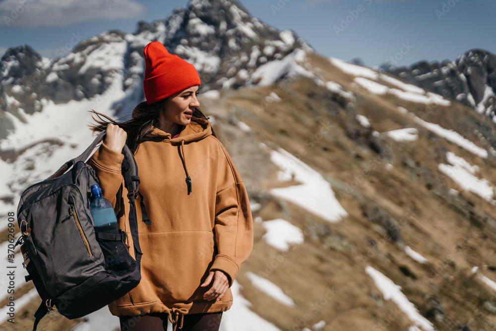  young girl in the mountains with a backpack. Active rest in one with nature