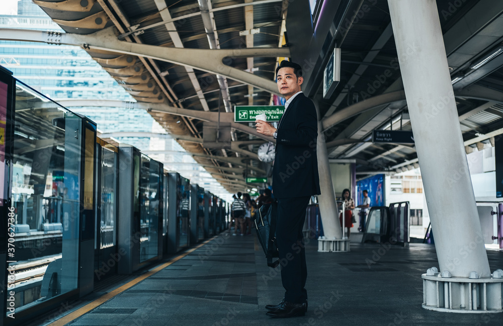 Businessman waiting sky train in Bangkok stock photo Businessman waiting sky train in Bangkok stock photo