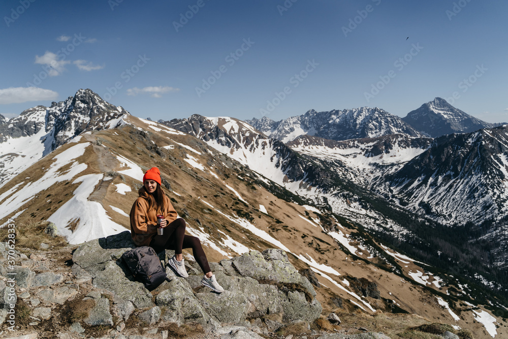  young girl in the mountains with a backpack. Active rest in one with nature