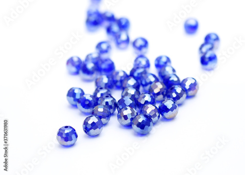 Blue round beads on a white background. beads to create jewelry and accessories. sewing accessories.