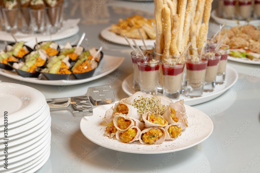 Bacon rolls with delicious filling and sprouted grains. Laid out on a white plate. Bacon rolls with delicious filling and sprouted grains. Laid out on a white plate.