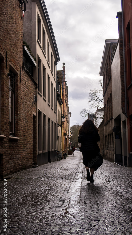 Silhouette woman walking in Bruges