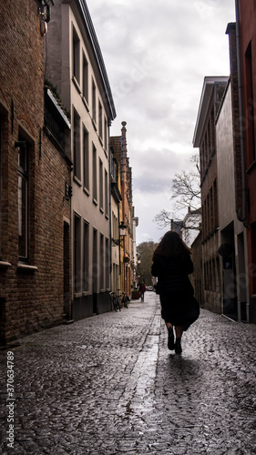 Silhouette woman walking in Bruges