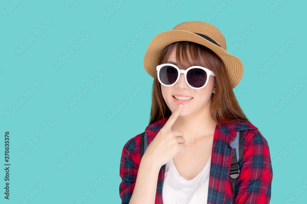Beautiful portrait young asian woman wear sunglasses and hat having backpack smile confident enjoy summer holiday isolated blue background, tourist model girl thinking idea planning travel concept. Beautiful portrait young asian woman wear sunglasses and hat having backpack smile confident enjoy summer holiday isolated blue background, tourist model girl thinking idea planning travel concept.